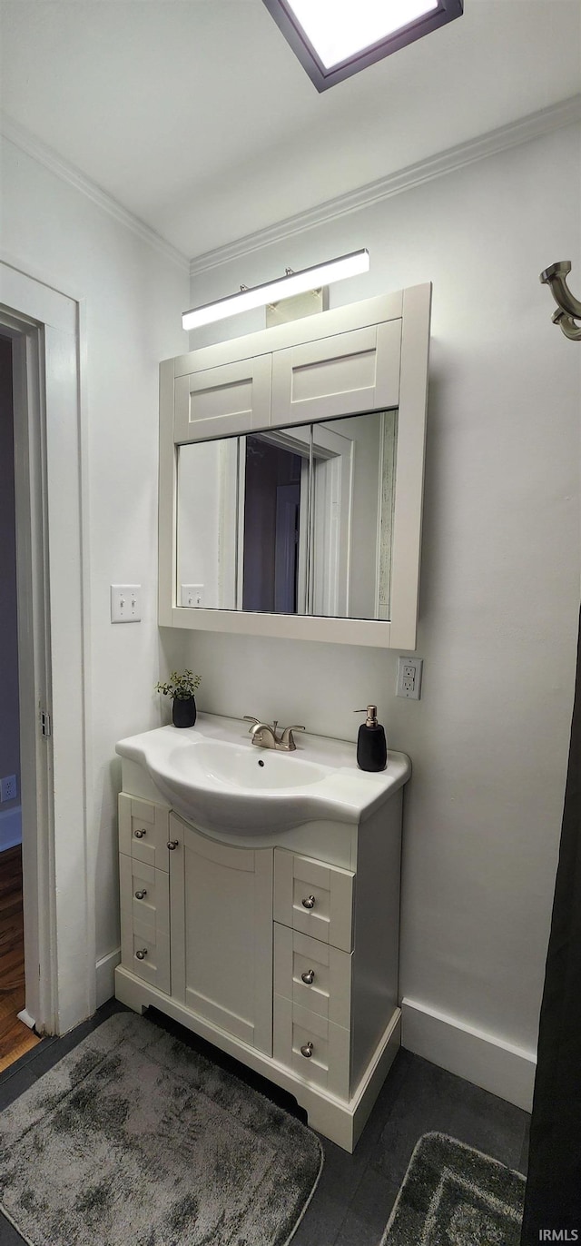 bathroom with vanity and ornamental molding