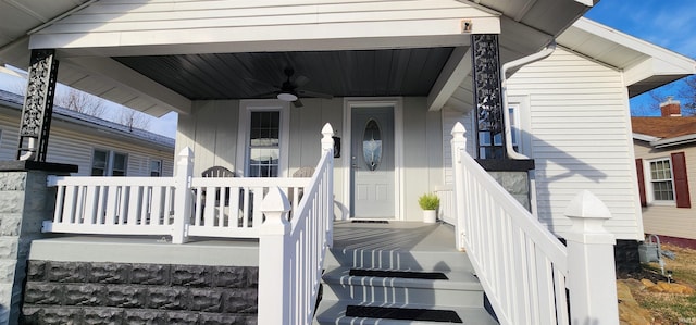 view of exterior entry featuring ceiling fan and a porch