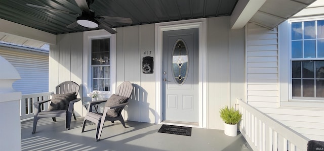 entrance to property featuring a porch and ceiling fan