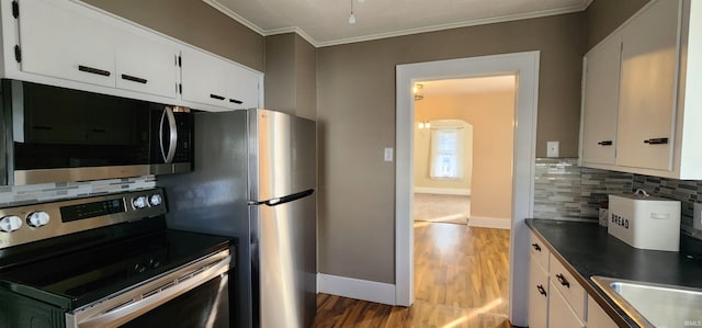 kitchen featuring white cabinetry, tasteful backsplash, and stainless steel appliances