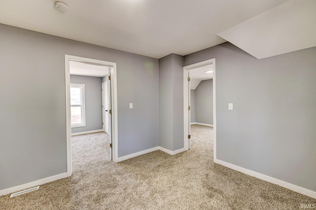 spare room with light carpet