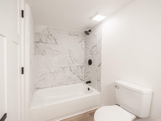 bathroom with toilet, shower / bath combination, and wood finished floors