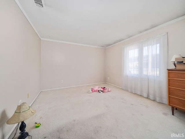 empty room featuring ornamental molding and light carpet