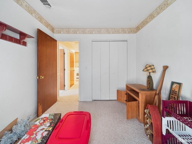 bedroom with a closet and light carpet