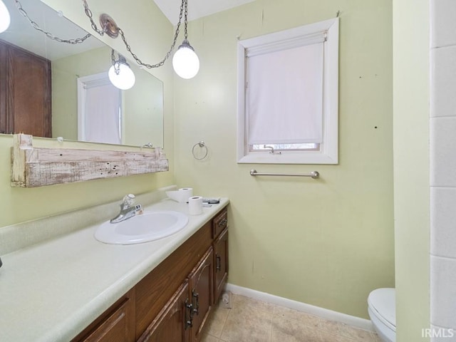 bathroom with vanity, tile patterned floors, and toilet