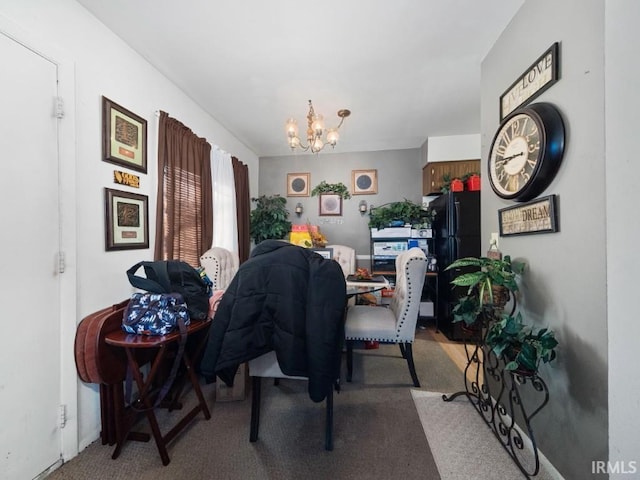 dining room with carpet floors and a chandelier