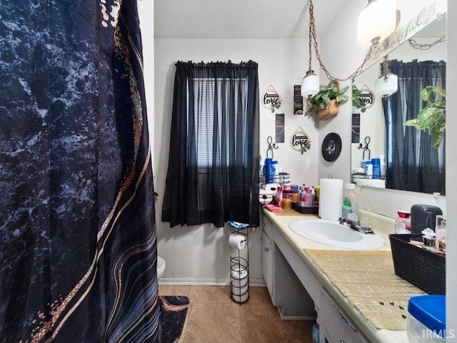 bathroom featuring vanity, toilet, and tile patterned flooring