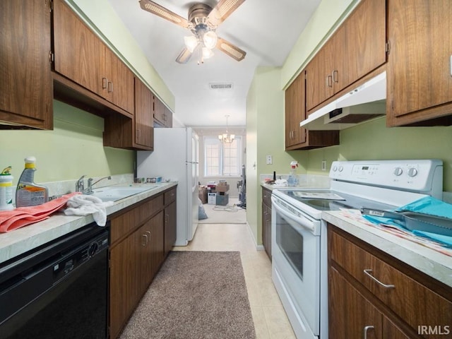 kitchen featuring sink, ceiling fan with notable chandelier, white appliances, and light tile patterned floors