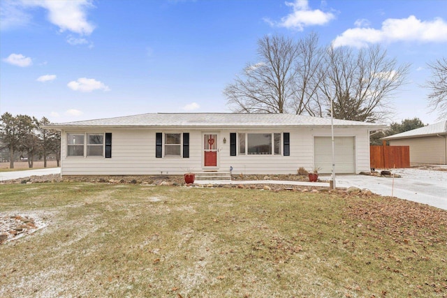 single story home featuring a garage and a front lawn