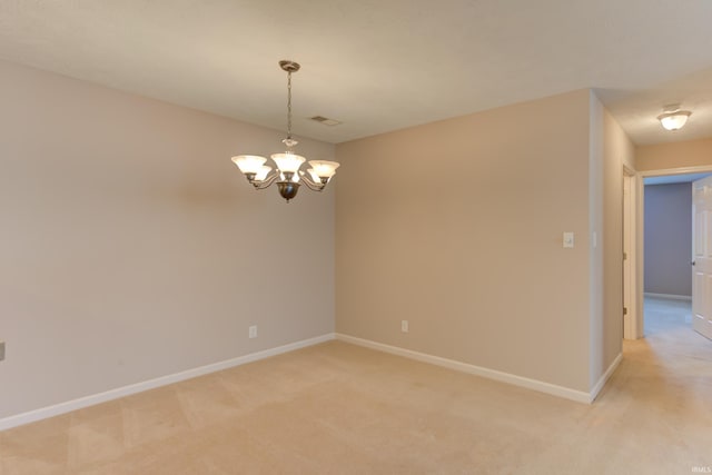 unfurnished room featuring light carpet and a chandelier