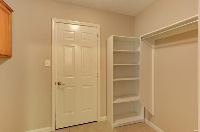spacious closet featuring light tile patterned floors