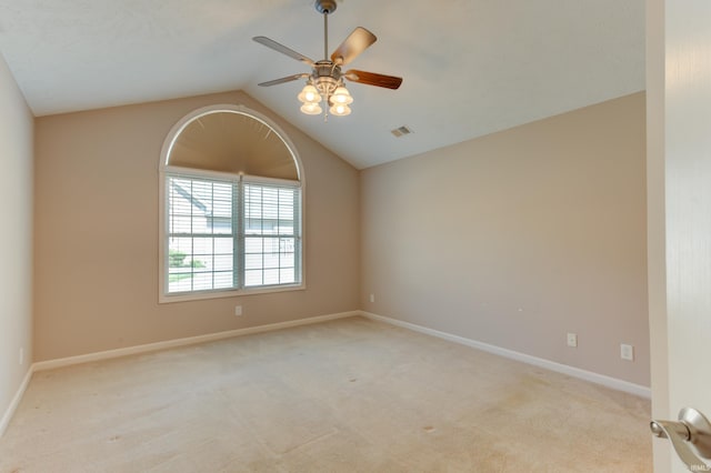 unfurnished room featuring vaulted ceiling, light carpet, and ceiling fan