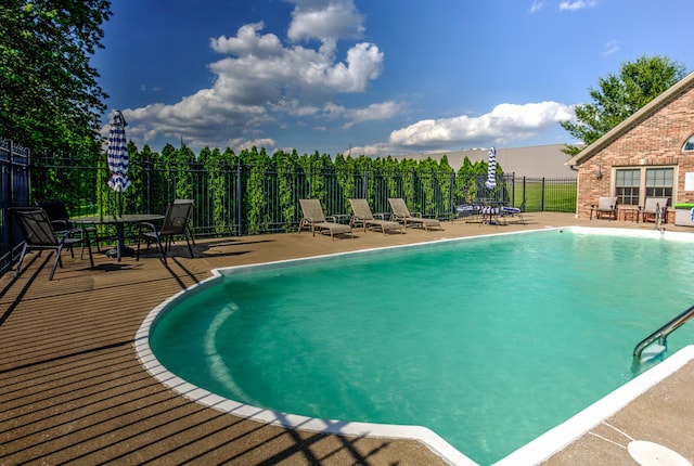 view of swimming pool with a patio area