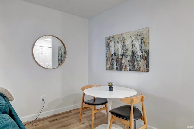 dining space with light hardwood / wood-style flooring