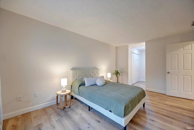 bedroom featuring a closet and light hardwood / wood-style flooring