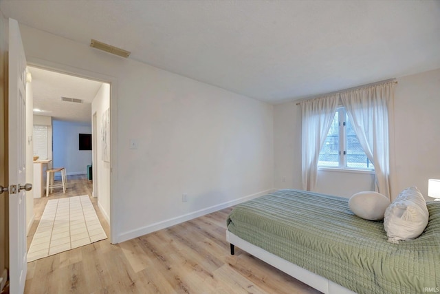 bedroom with light hardwood / wood-style flooring