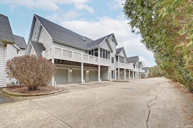 view of side of property with a garage and a sunroom