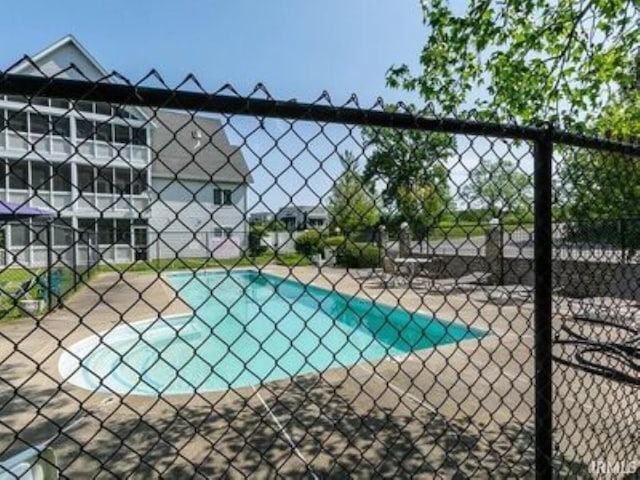 view of sport court with a fenced in pool