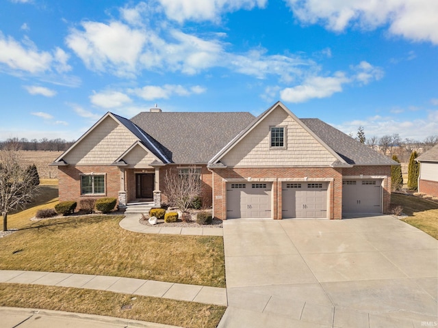 craftsman-style home featuring a garage and a front lawn