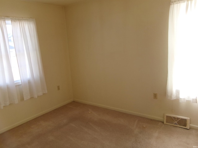 unfurnished room with light colored carpet