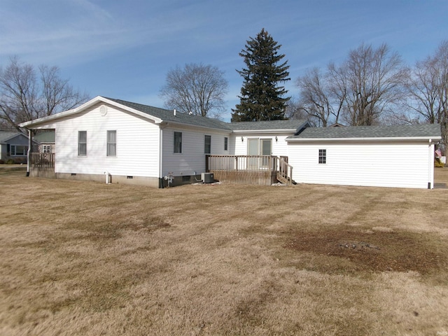 exterior space with cooling unit, a deck, and a lawn