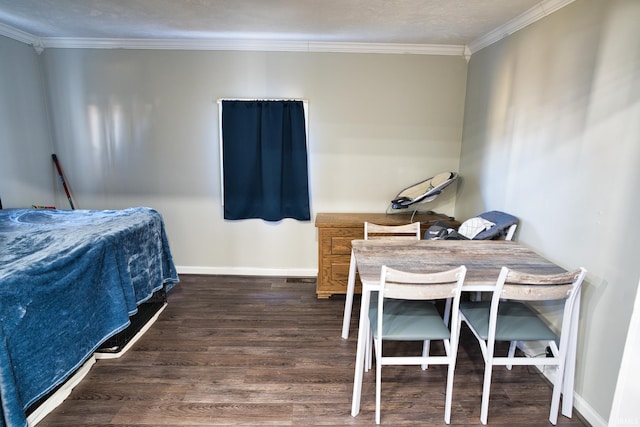 bedroom with ornamental molding and dark hardwood / wood-style floors