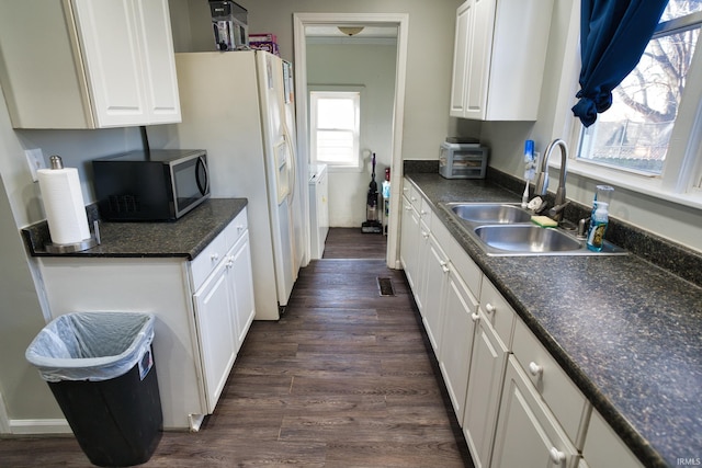 kitchen with dark wood-type flooring, sink, and white cabinets