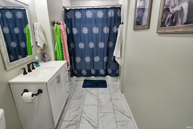 bathroom featuring vanity and curtained shower