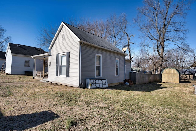 exterior space with a storage shed and a lawn