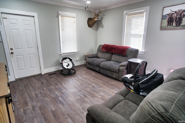 living room featuring hardwood / wood-style flooring and crown molding