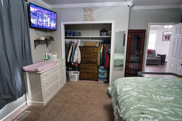 bedroom featuring crown molding, carpet, and a closet