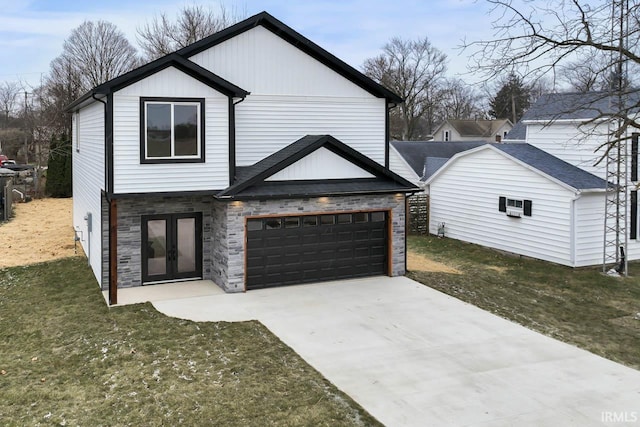 view of front of house featuring a garage, a front yard, and french doors