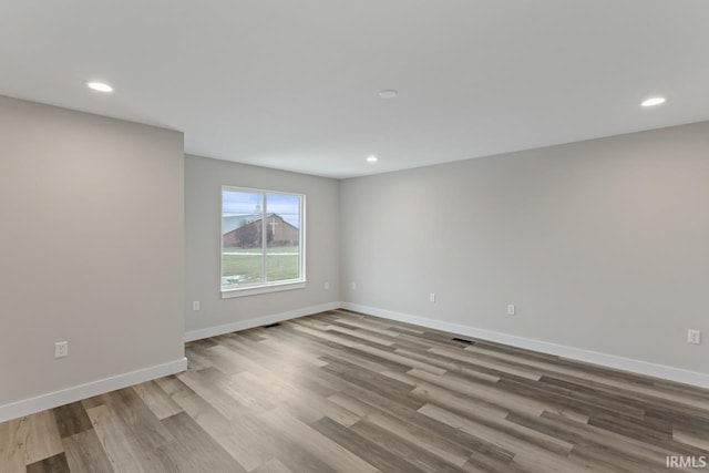 spare room featuring light hardwood / wood-style flooring