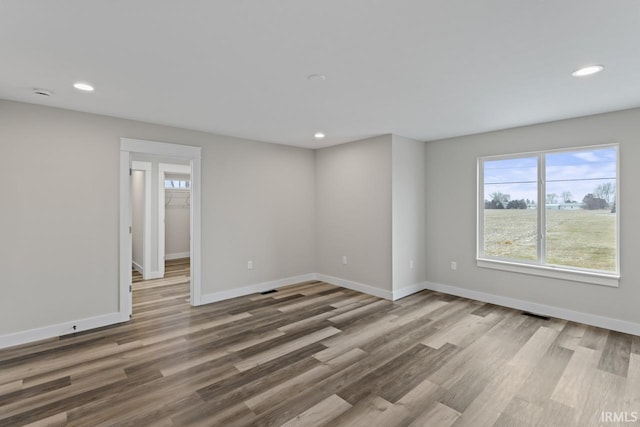 empty room with hardwood / wood-style floors