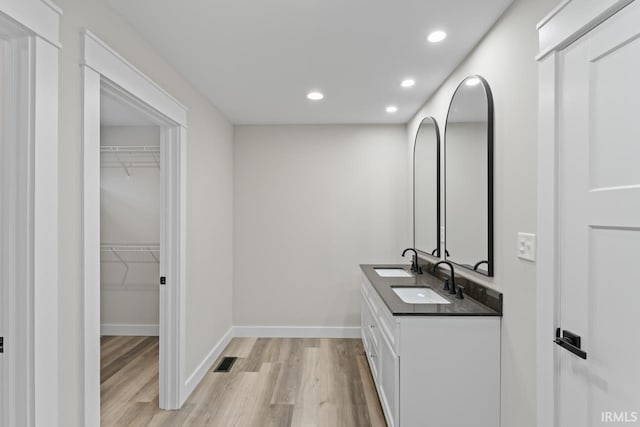 bathroom with hardwood / wood-style flooring and vanity