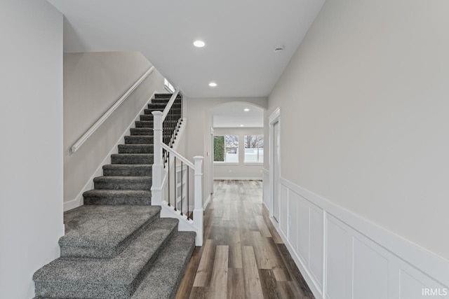 stairway with hardwood / wood-style floors