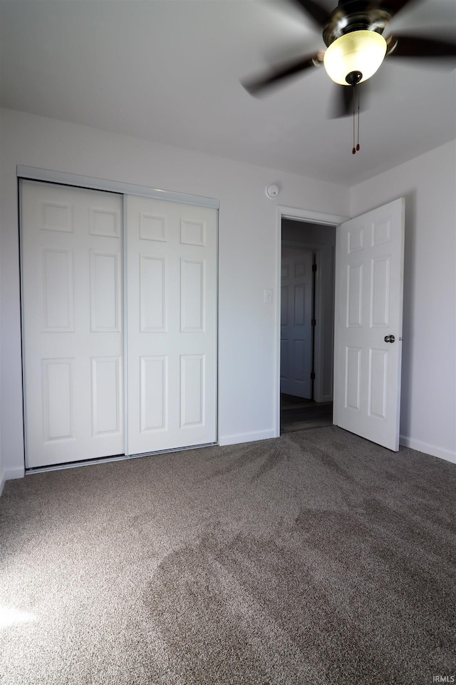 unfurnished bedroom with carpet floors, a closet, and ceiling fan