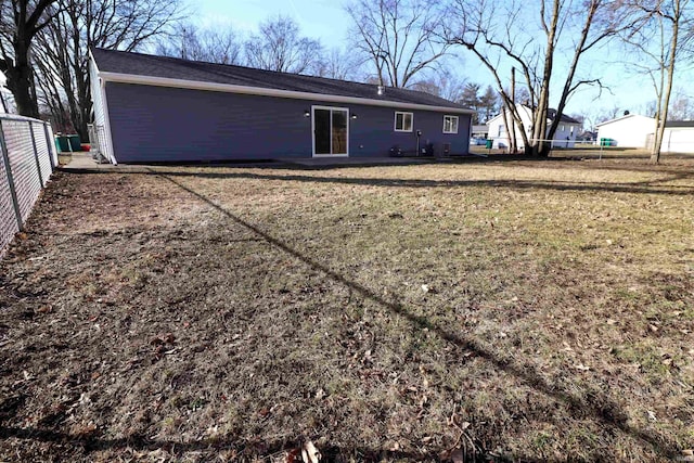 rear view of property with a lawn