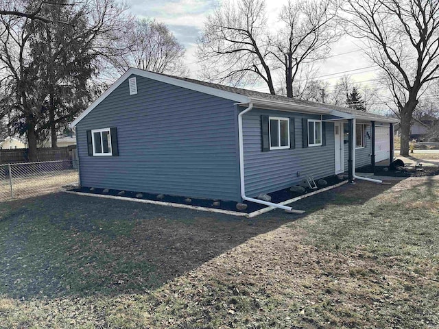 view of home's exterior featuring a garage and a yard