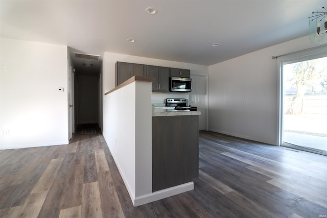 kitchen featuring appliances with stainless steel finishes and dark hardwood / wood-style floors