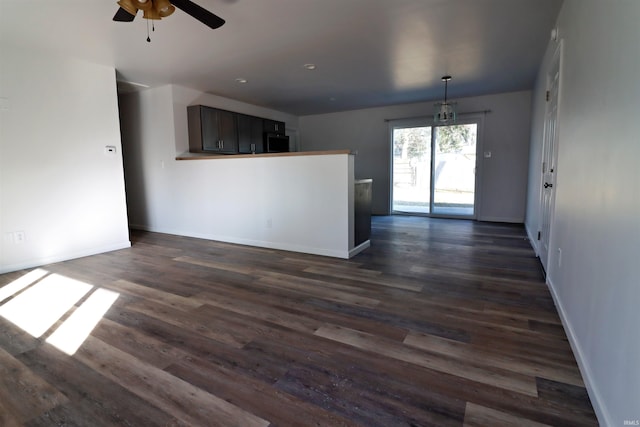 interior space featuring dark wood-type flooring and ceiling fan