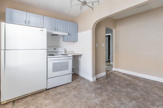 kitchen with decorative backsplash, white appliances, and a textured ceiling