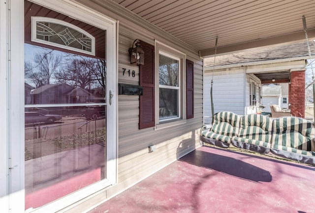 view of exterior entry featuring a porch