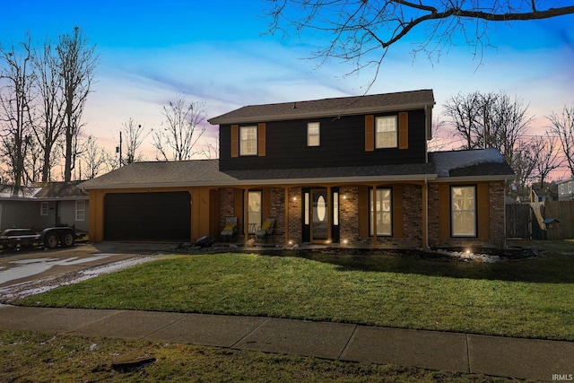 view of front facade with a garage, a yard, and covered porch