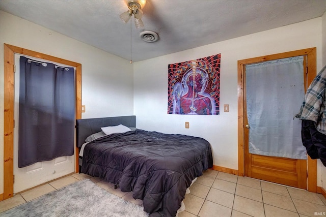 tiled bedroom featuring ceiling fan