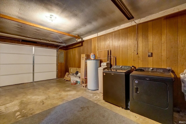 interior space featuring electric panel, washing machine and dryer, and wood walls