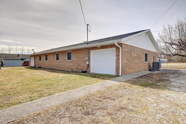 view of side of property featuring a garage and a lawn