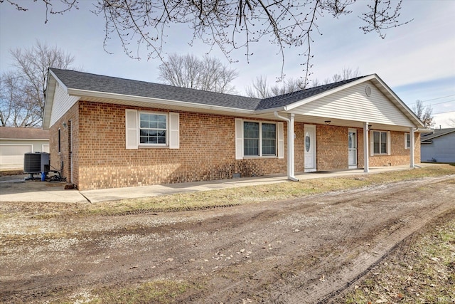 single story home with central air condition unit and covered porch