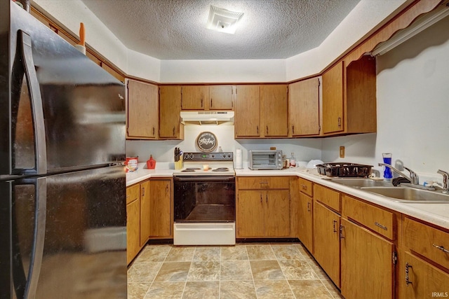 kitchen with black refrigerator, sink, a textured ceiling, and white range with electric stovetop