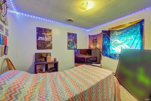 bedroom with a textured ceiling and carpet